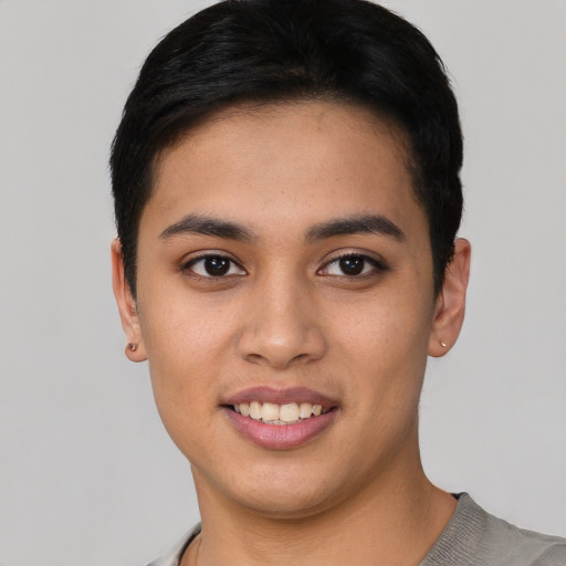 Joyful asian young-adult male with short  black hair and brown eyes