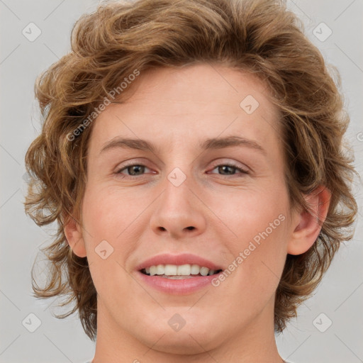 Joyful white young-adult female with medium  brown hair and green eyes