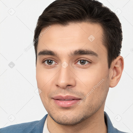 Joyful white young-adult male with short  brown hair and brown eyes