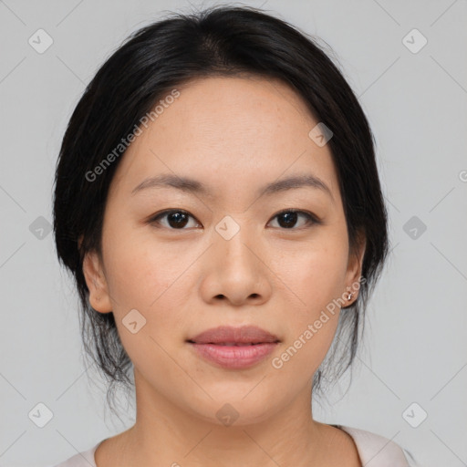 Joyful asian young-adult female with medium  black hair and brown eyes