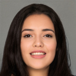 Joyful white young-adult female with long  black hair and brown eyes