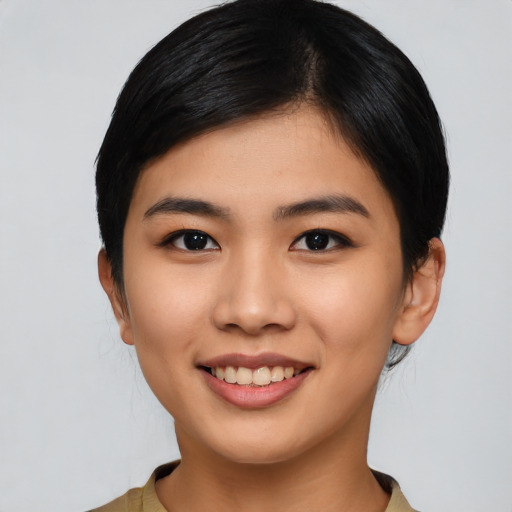 Joyful asian young-adult female with short  black hair and brown eyes