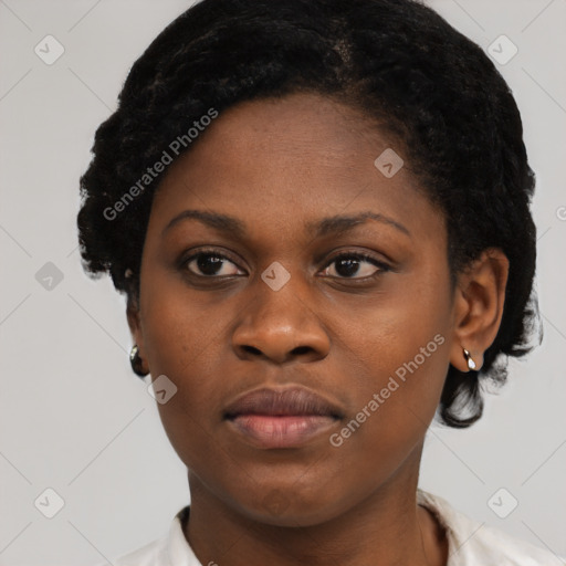 Joyful black young-adult female with short  black hair and brown eyes