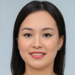 Joyful asian young-adult female with long  brown hair and brown eyes