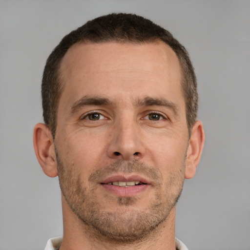 Joyful white adult male with short  brown hair and brown eyes