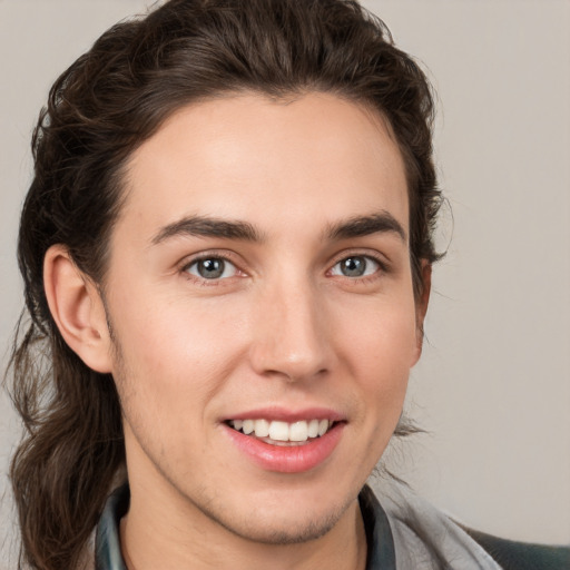 Joyful white young-adult male with medium  brown hair and brown eyes