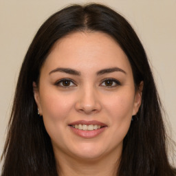 Joyful white young-adult female with long  brown hair and brown eyes