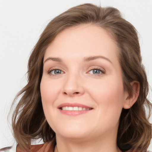 Joyful white young-adult female with medium  brown hair and blue eyes