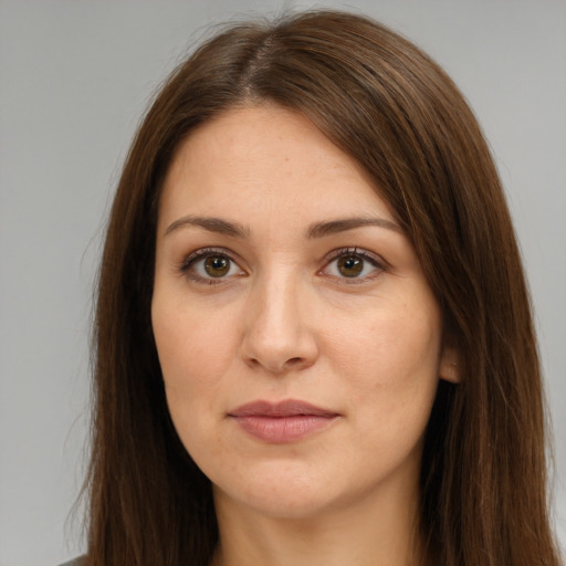 Joyful white young-adult female with long  brown hair and brown eyes