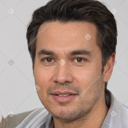 Joyful white adult male with short  black hair and brown eyes