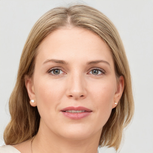 Joyful white young-adult female with medium  brown hair and blue eyes