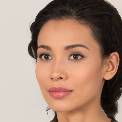 Joyful latino young-adult female with long  brown hair and brown eyes