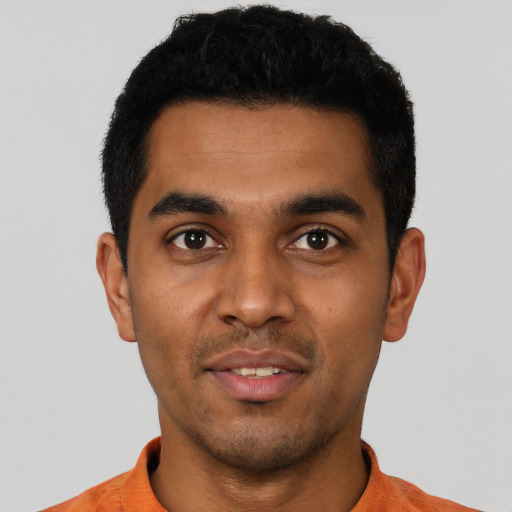 Joyful latino young-adult male with short  black hair and brown eyes