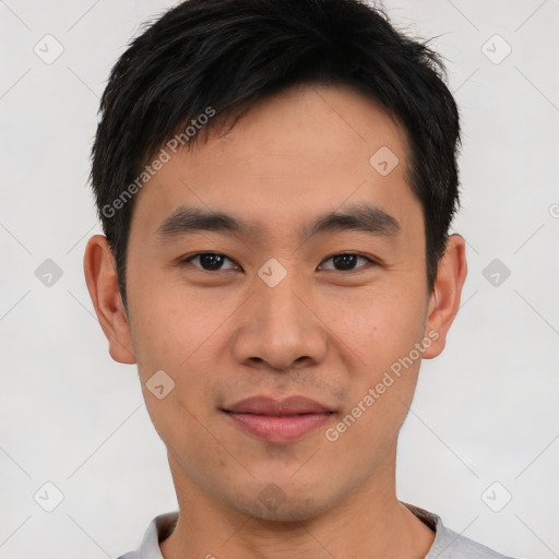 Joyful asian young-adult male with short  black hair and brown eyes