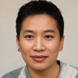 Joyful asian young-adult male with short  black hair and brown eyes