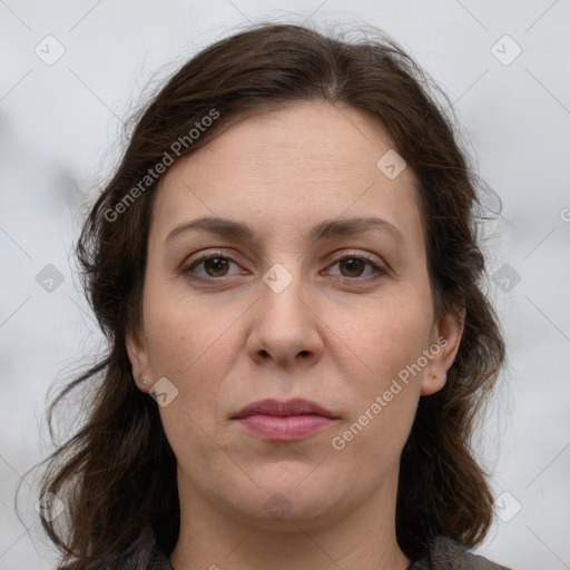 Joyful white adult female with long  brown hair and grey eyes