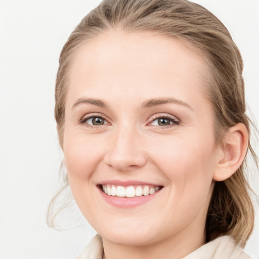 Joyful white young-adult female with medium  brown hair and blue eyes