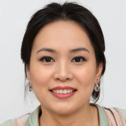 Joyful asian young-adult female with medium  brown hair and brown eyes