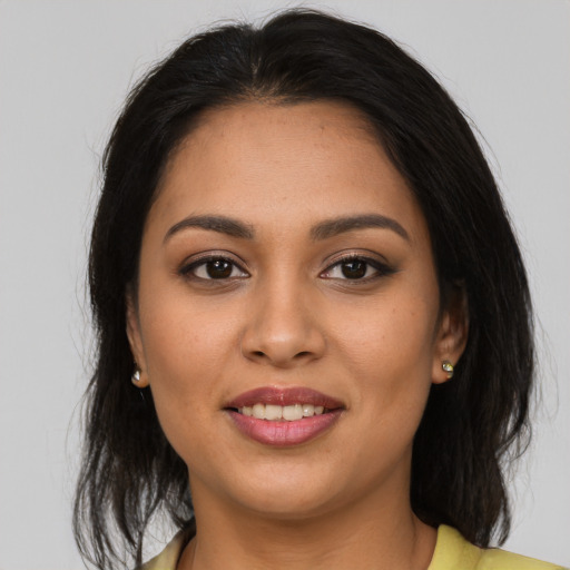 Joyful latino young-adult female with medium  brown hair and brown eyes