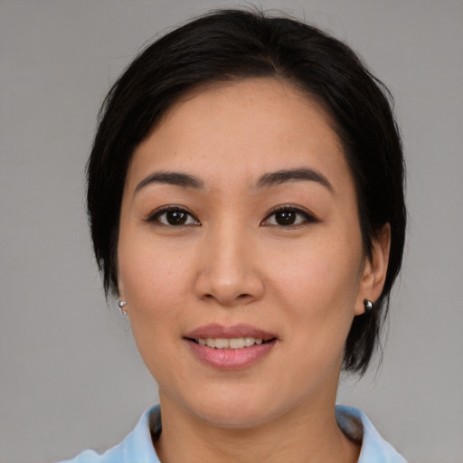 Joyful asian young-adult female with medium  black hair and brown eyes