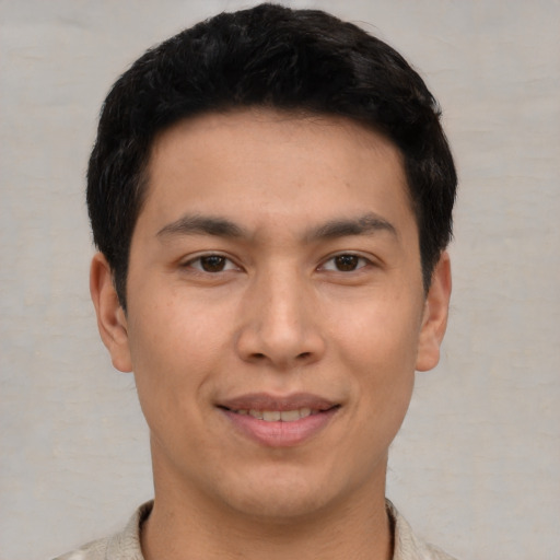 Joyful asian young-adult male with short  brown hair and brown eyes