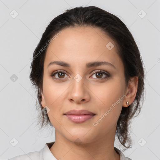 Joyful latino young-adult female with medium  brown hair and brown eyes