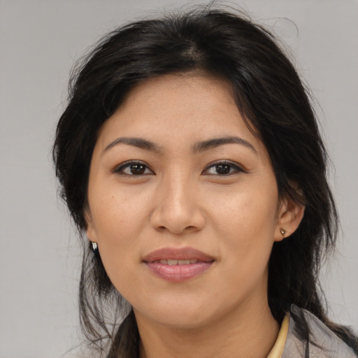 Joyful asian adult female with medium  brown hair and brown eyes