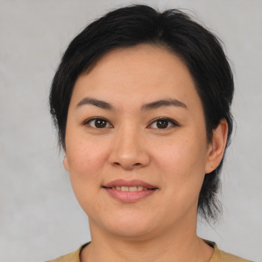 Joyful asian young-adult female with medium  brown hair and brown eyes