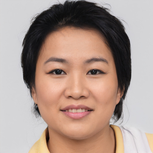 Joyful asian young-adult female with medium  black hair and brown eyes