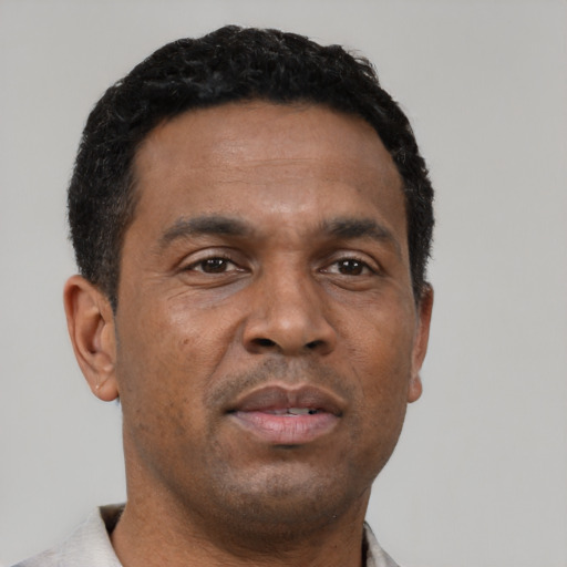 Neutral latino adult male with short  black hair and brown eyes