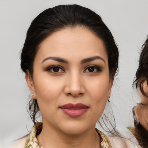 Joyful latino young-adult female with medium  brown hair and brown eyes