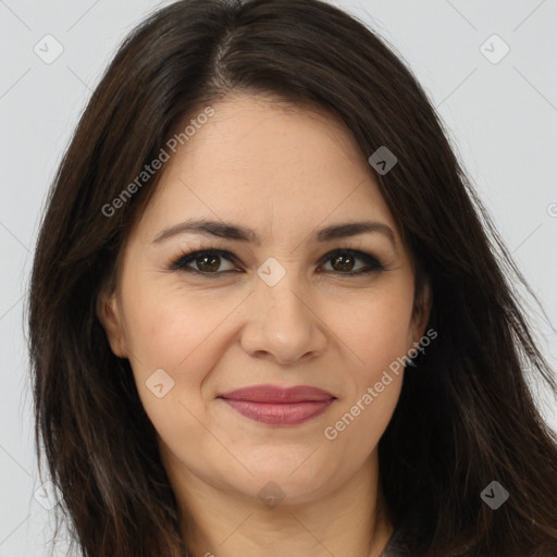 Joyful white adult female with long  brown hair and brown eyes