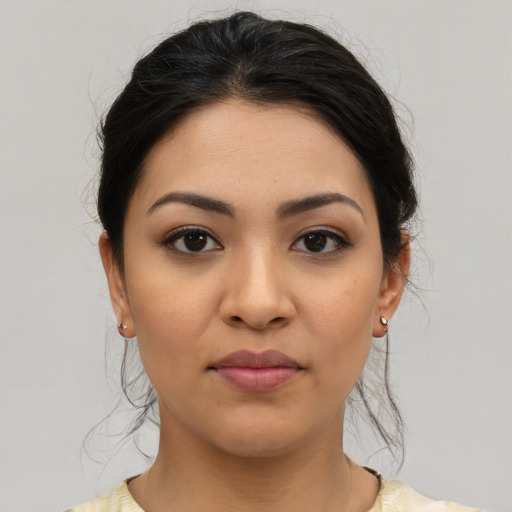 Joyful latino young-adult female with medium  brown hair and brown eyes