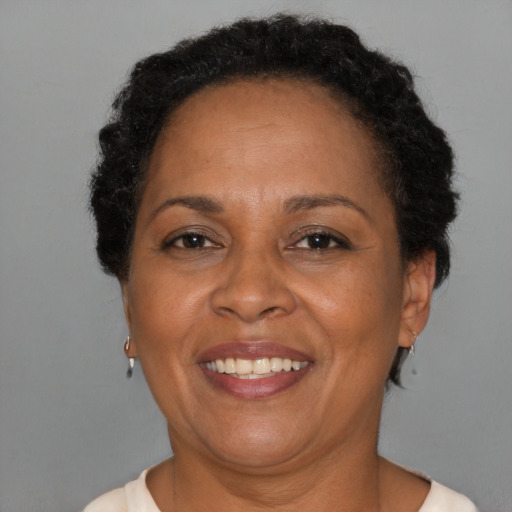 Joyful black adult female with short  brown hair and brown eyes