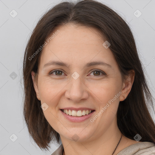 Joyful white adult female with long  brown hair and grey eyes