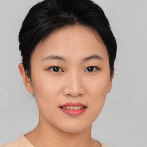 Joyful asian young-adult female with short  black hair and brown eyes
