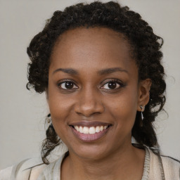 Joyful black young-adult female with medium  brown hair and brown eyes