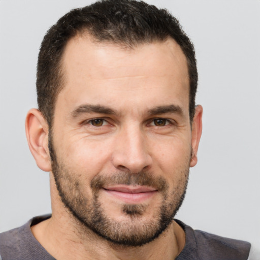 Joyful white adult male with short  brown hair and brown eyes