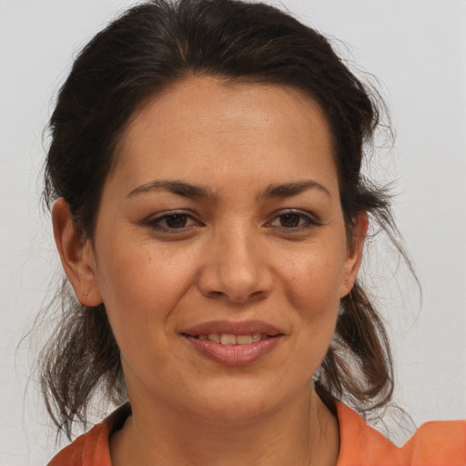Joyful white adult female with medium  brown hair and brown eyes