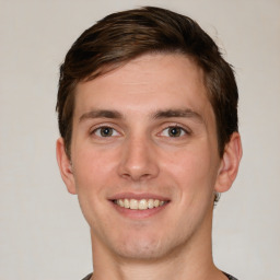 Joyful white young-adult male with short  brown hair and grey eyes