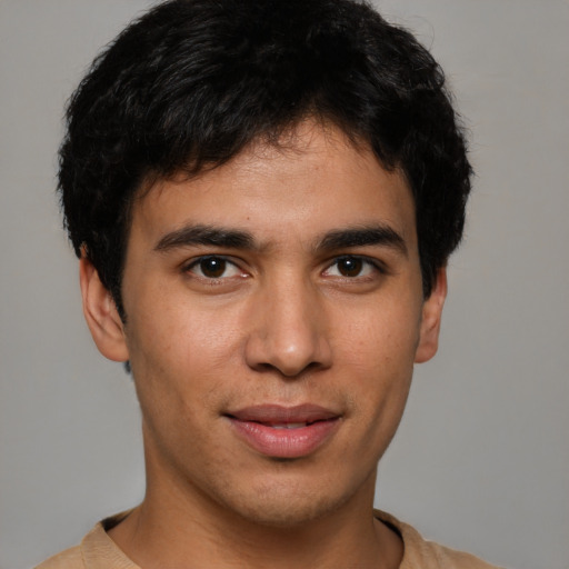 Joyful white young-adult male with short  black hair and brown eyes