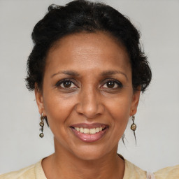 Joyful black adult female with short  brown hair and brown eyes