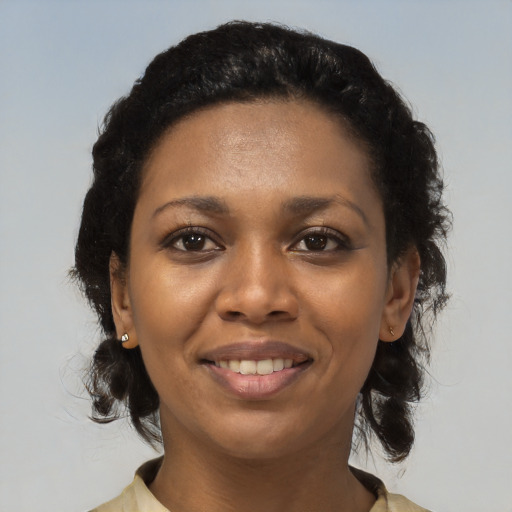 Joyful black young-adult female with medium  black hair and brown eyes