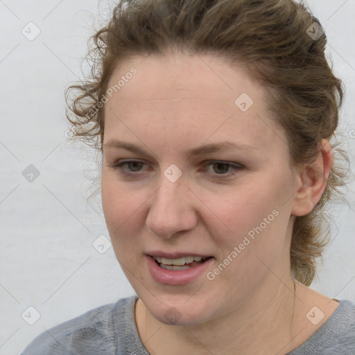 Joyful white young-adult female with medium  brown hair and blue eyes