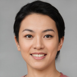 Joyful asian young-adult female with medium  black hair and brown eyes