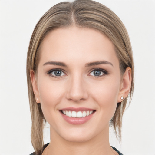 Joyful white young-adult female with medium  brown hair and grey eyes