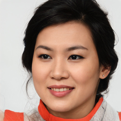 Joyful asian young-adult female with medium  black hair and brown eyes