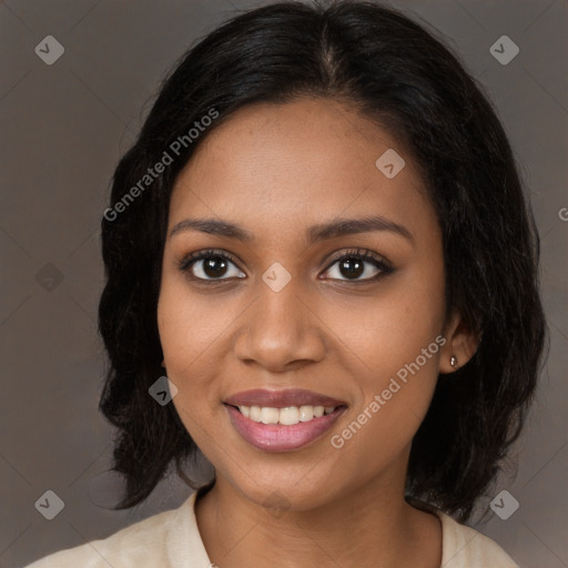 Joyful black young-adult female with long  brown hair and brown eyes