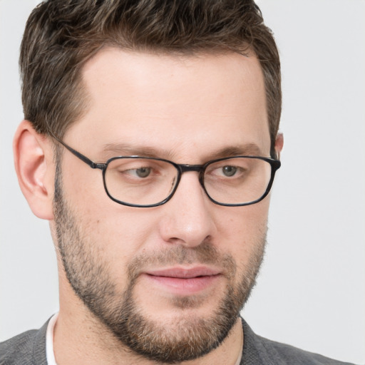 Joyful white adult male with short  brown hair and grey eyes