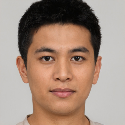 Joyful asian young-adult male with short  brown hair and brown eyes